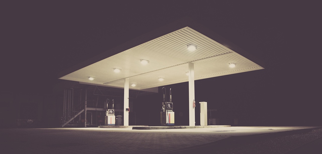 Empty petrol station at night with dramatic lighting, representing rising fuel and business costs in Australia
